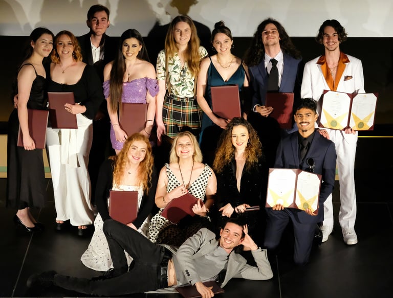 a group of people standing around a man holding a plaque