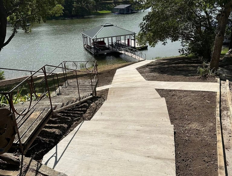 a concrete pathway heading down to the lake