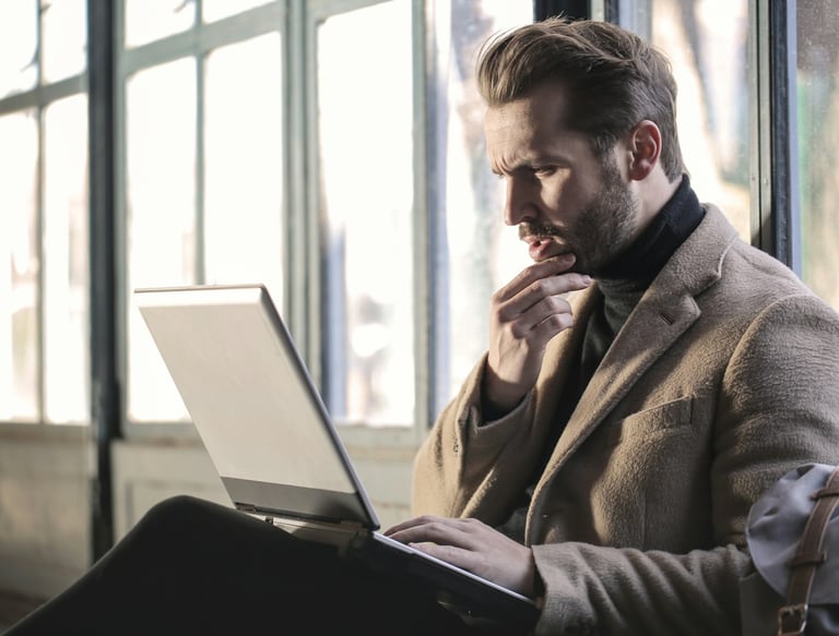 a man in a suit and tie is sitting on a bench