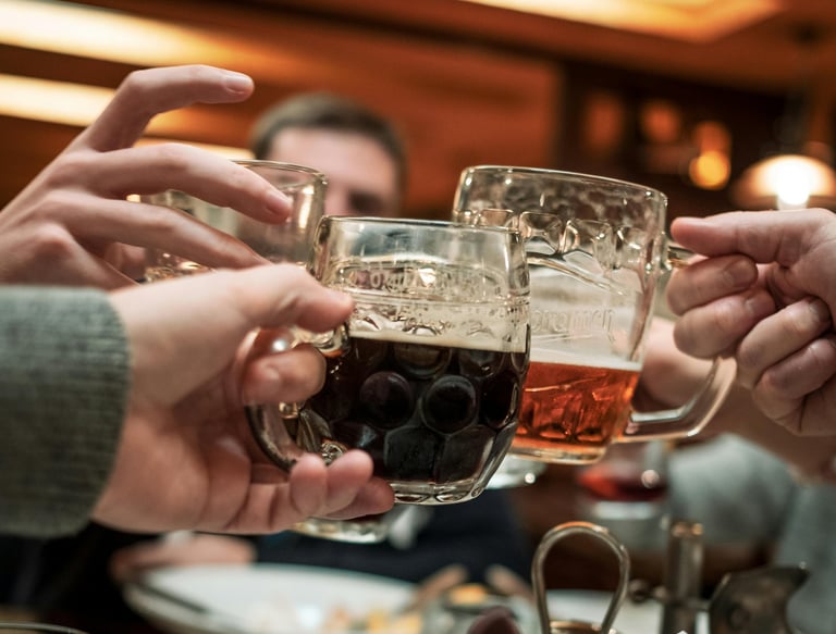 Beer mugs raised in a toast