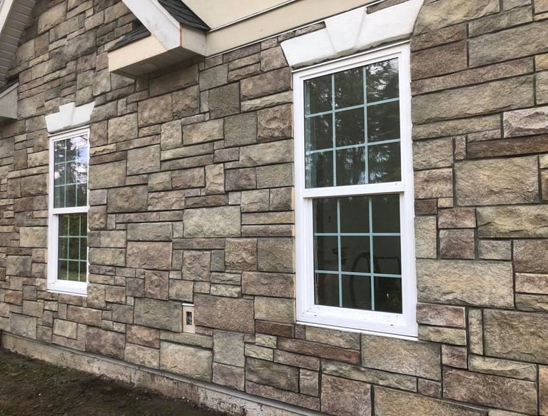 a house with a brick wall and windows