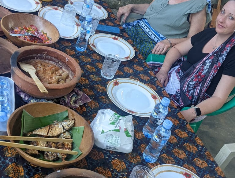 a group of people sitting around a table with plates of food