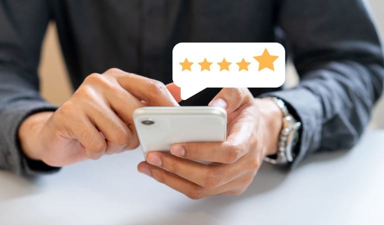 a man holding a cell phone with five stars on it