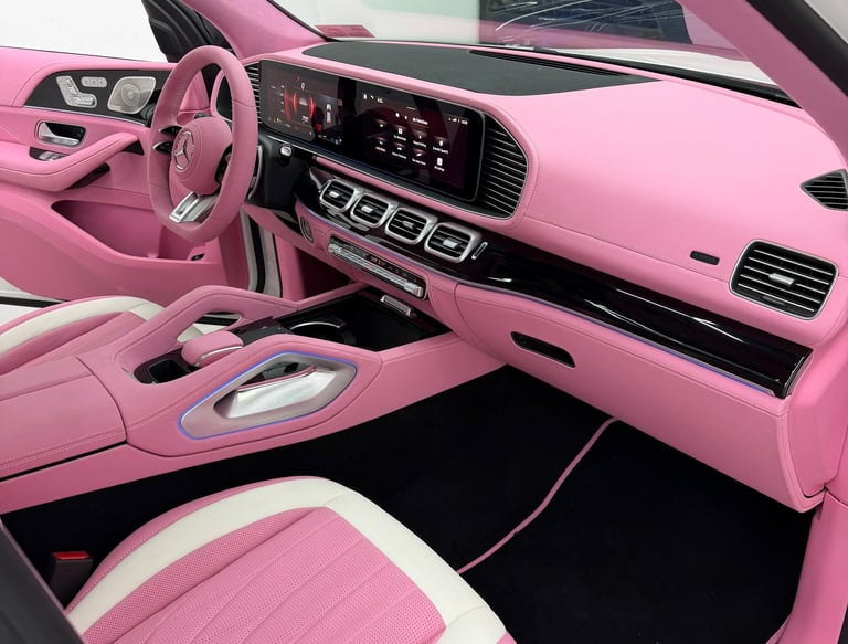 Custom pink and white leather interior of a luxury Mercedes-Benz SUV dashboard and seats.