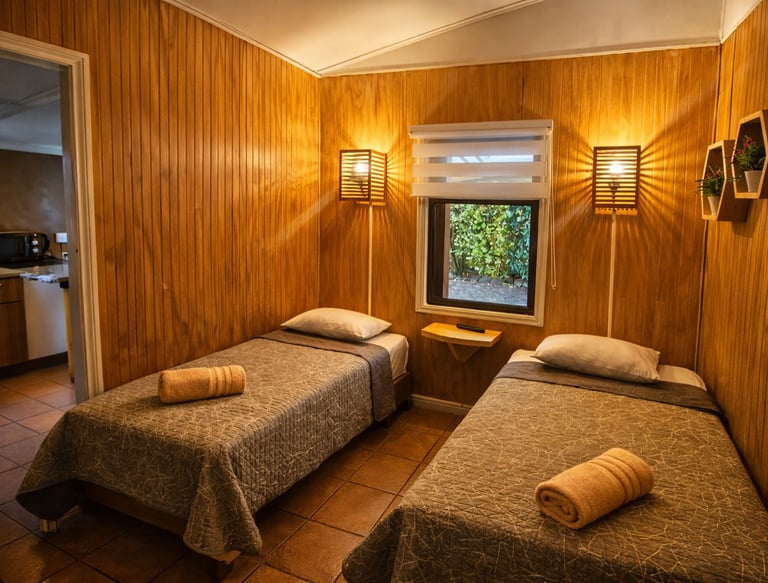 Rustic cabin bedroom with twin beds, warm wood-paneled walls, and cozy ambient lighting.