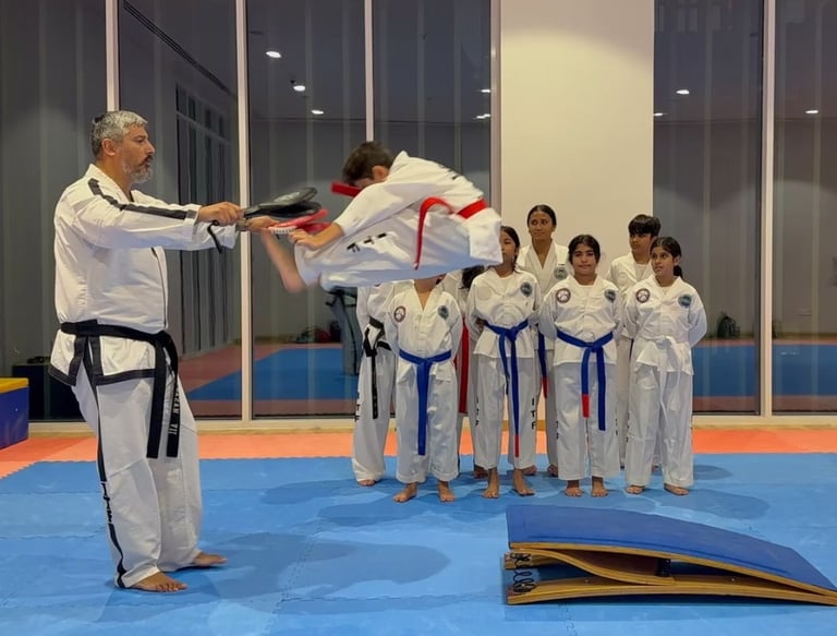 Master Carlos Bazan 7th Dan ITF Taekwondo instructor Dubai coaching student high kick