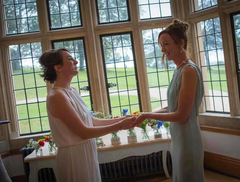 LGBTQ+ wedding couple saying their vows