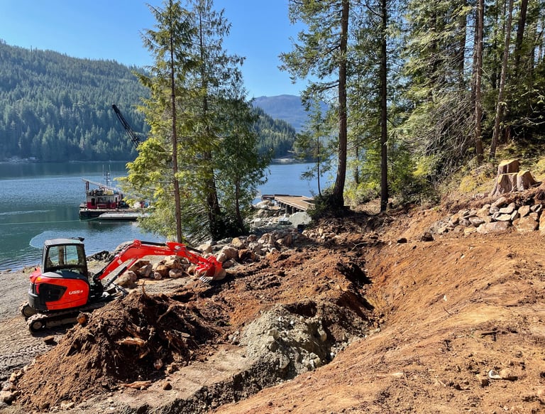 Excavator shaping land for water capture Vancouver Island