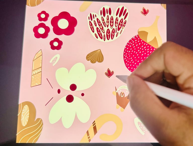 Surface pattern designer drawing playful floral and abstract motifs on a tablet