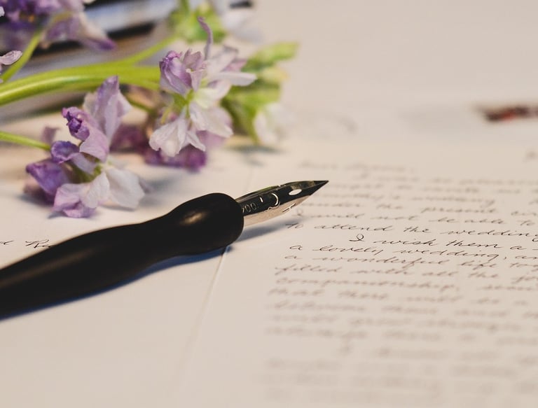 Fountain pen and flowers on a letter for mindful journaling.