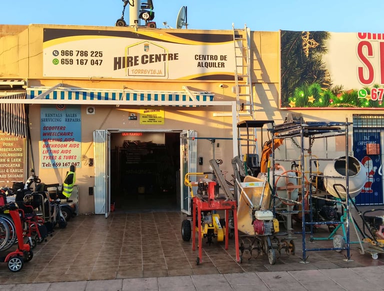 Torrevieja hire centre storefront displaying mobility scooters and construction equipment rentals.