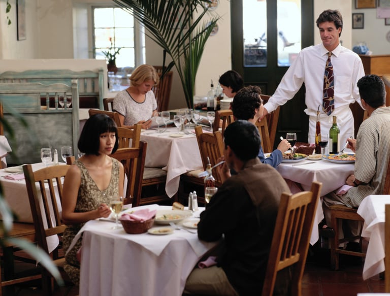 People sitting in a restaurant to connote restaurant AI