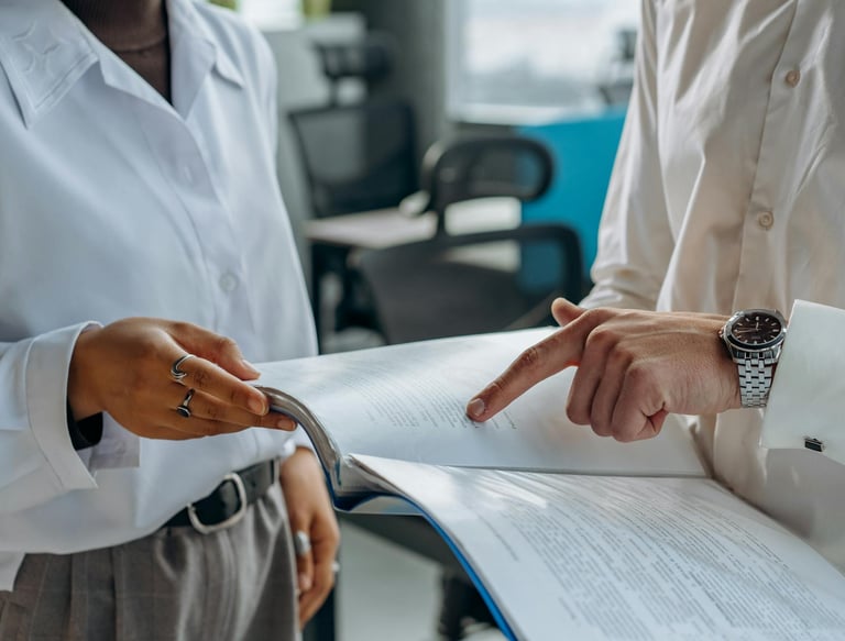a man and woman in business attire are standing in a room
