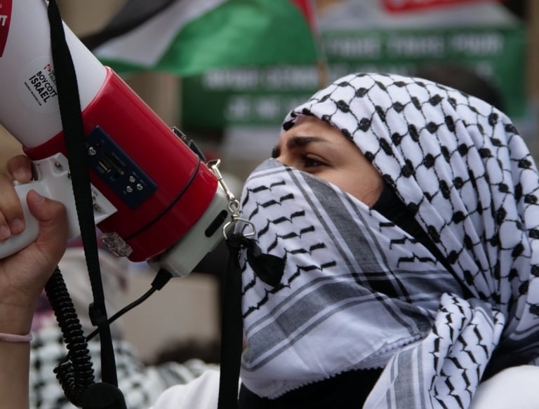 a man in a white shirt and black scarf