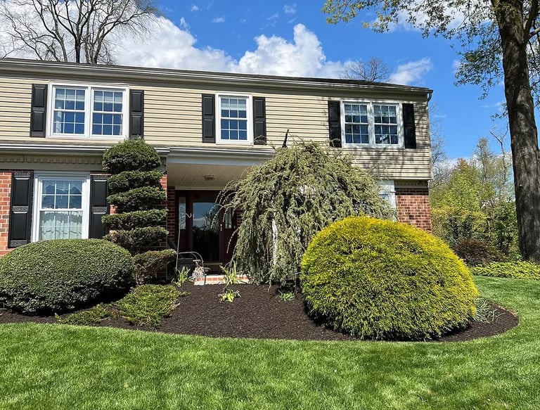 excellent landscaping and hardscaping of grass, stones and trees by NP Landscaping