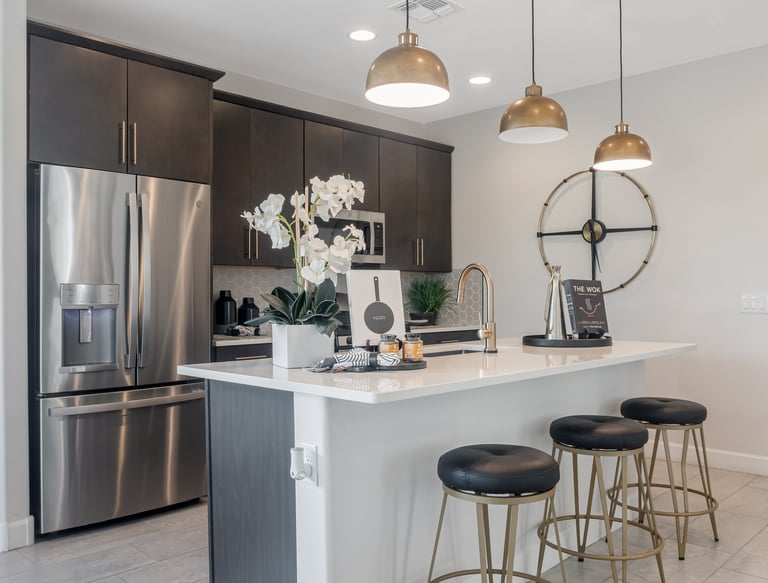 a kitchen with a large island and a bar stool