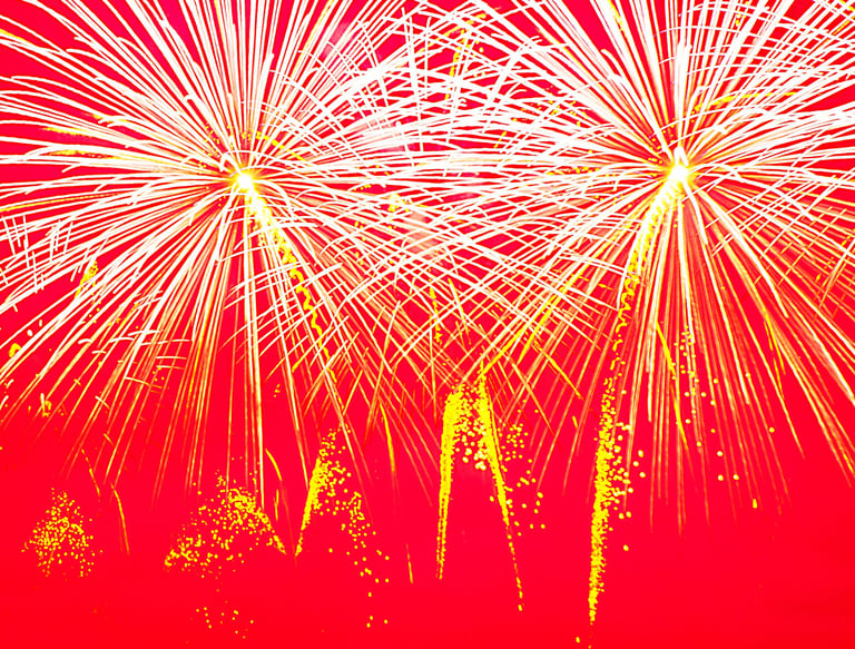 white fireworks against a pink backdrop