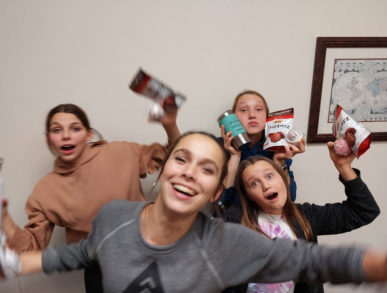 a group of people standing around a table
