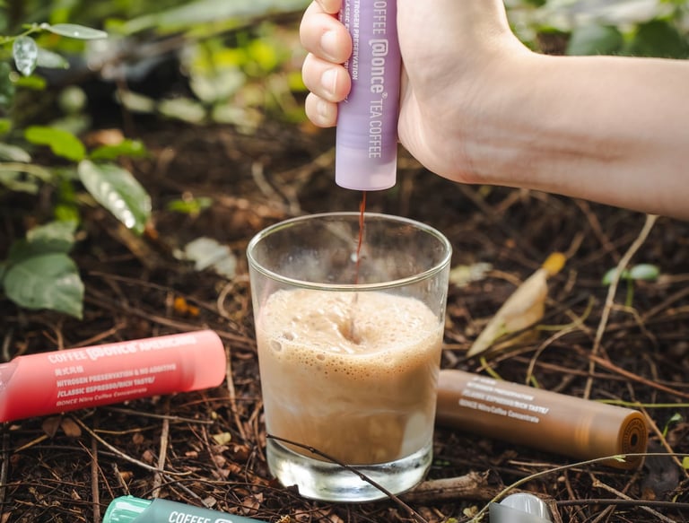 a person is holding a bottle of liquid in their hand
