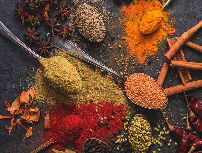 a variety of spices cumin staranish coriander are scattered on a table