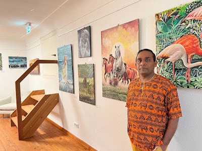 Artists Perl Perera with some of his work