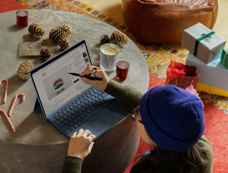 Consumer advice and product reviews shown on a laptop while holiday shopping at home with gifts, can
