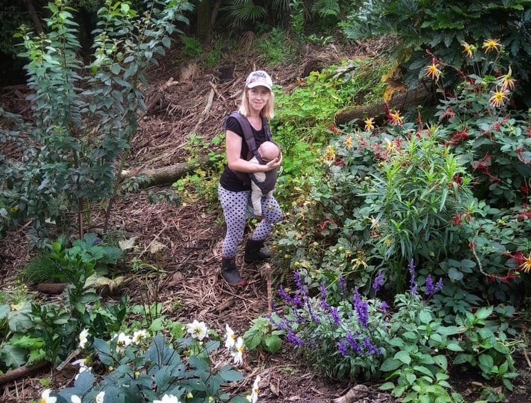mum in food forest with baby