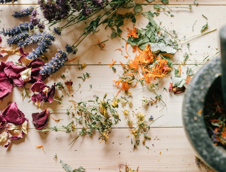 a picture of various flowers and herbs and a mortar
