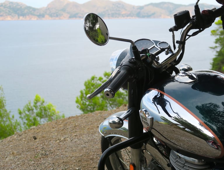 A Royal Enfield Classic overlooking Alcudia Bay in Mallorca