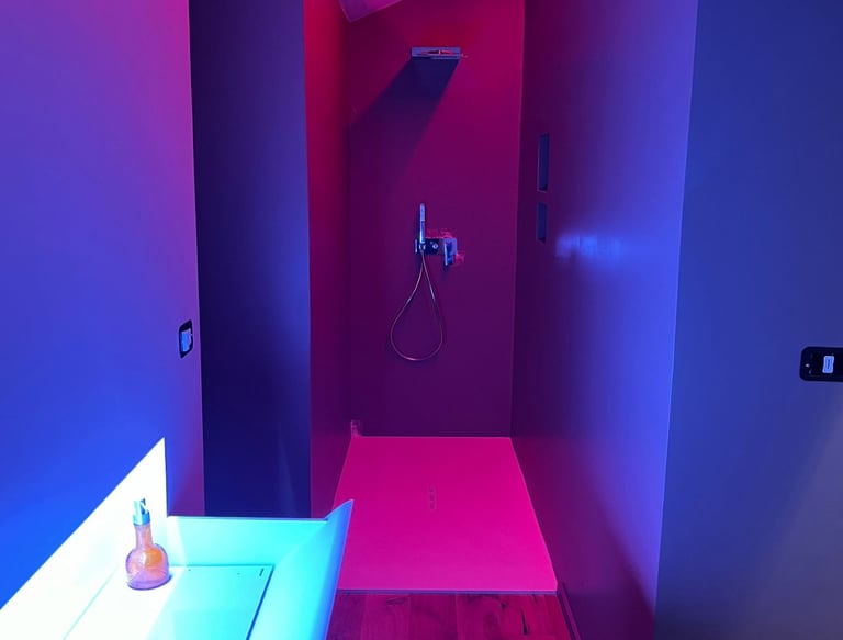 a bathroom with a pink and blue light