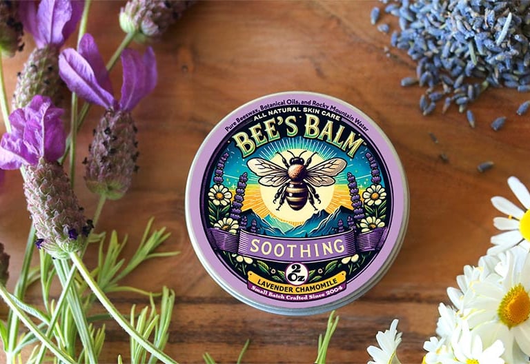 Tin of Bee's Balm Soothing - Lavender Chamomile - salve surrounded by lavender & chamomile flowers
