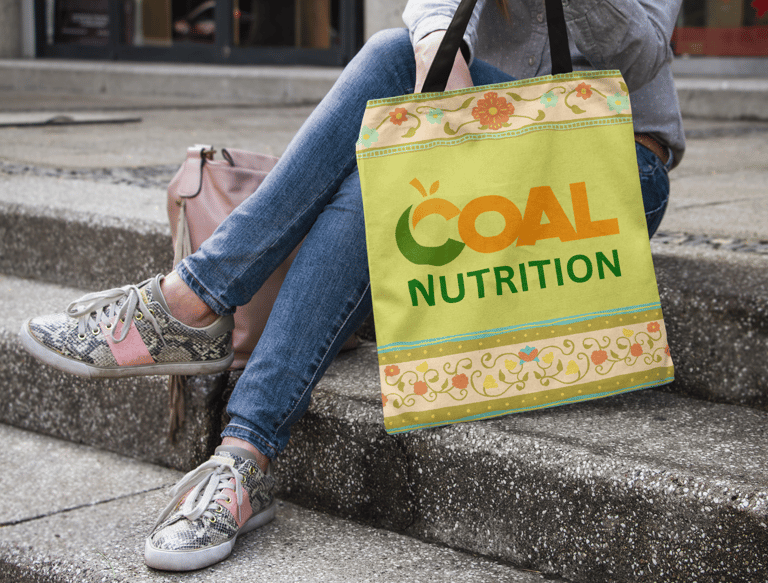 Une femme assise sur des marches tenant un sac avec le logo nutrition orné de motifs floraux.
