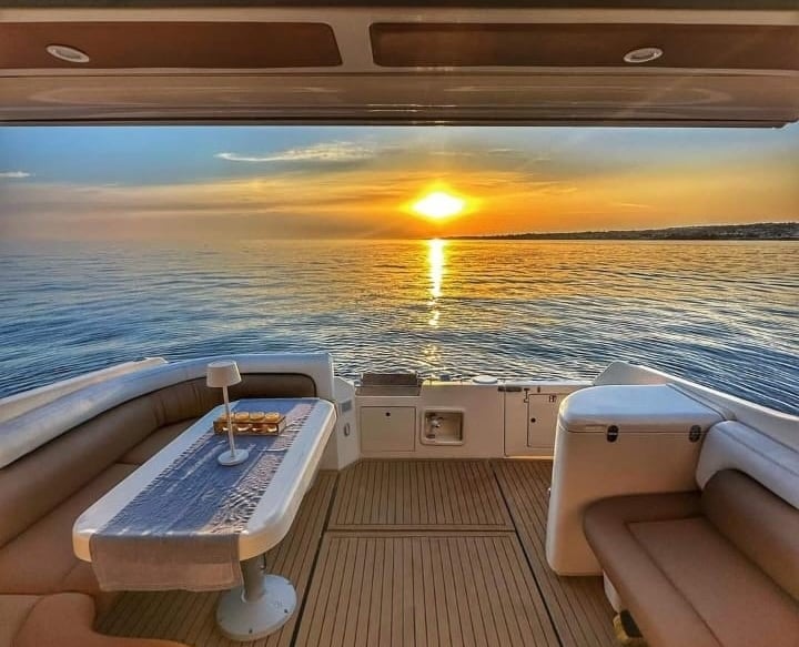 Luxury yacht deck at sunset during private boat tour in Siracusa, Sicily