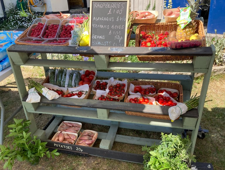 Fresh produce including strawberries and tomatoes on an outside stall