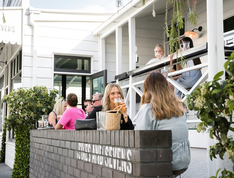 Two female guests are dining on a restaurant terrace