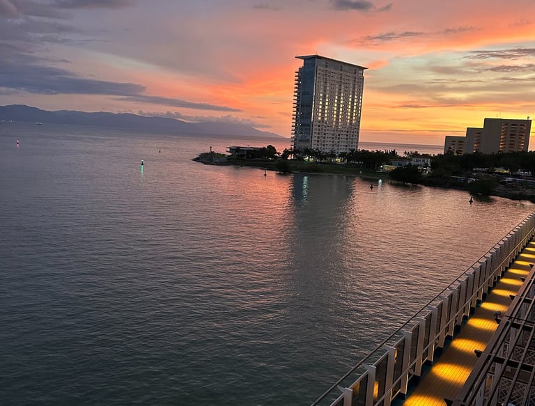 a view of a city at sunset with a boat in the water