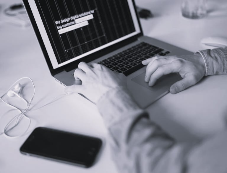 Image of a user typing on a laptop
