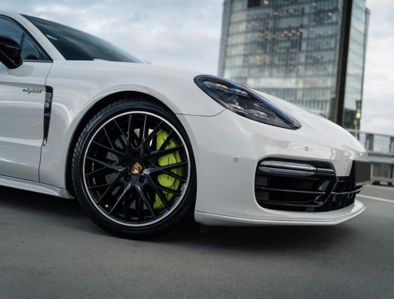 an Enlab white porsche panamera parked on a city street