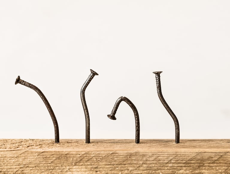 a group of nails on a piece of wood secret addiction