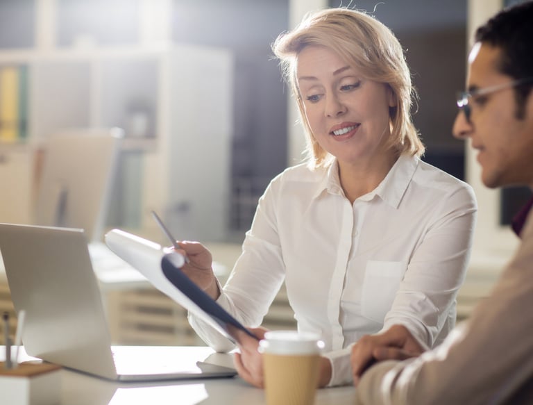 a woman sitting at a table with a man in a white shirt