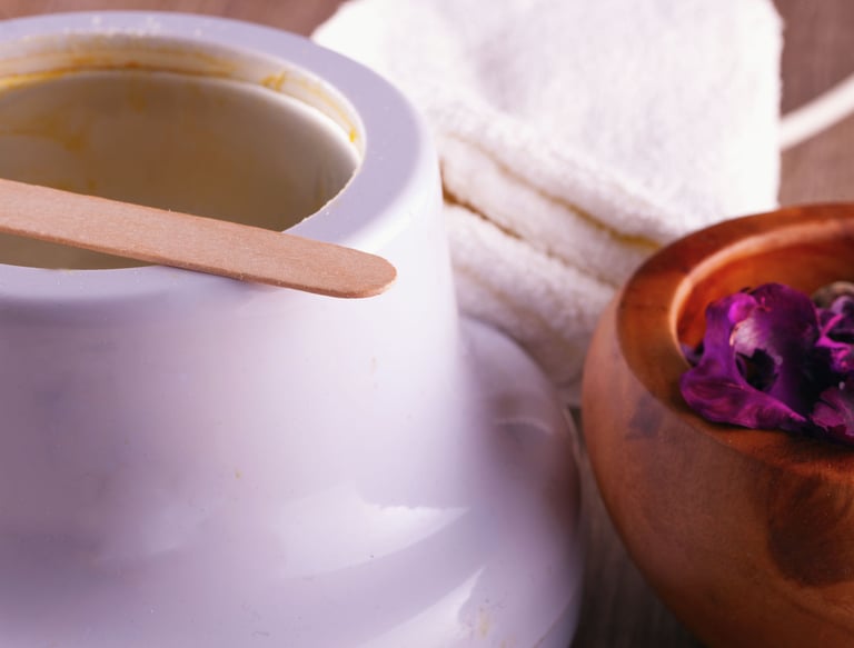 Professional hair removal kit featuring a wax warmer with wooden applicator and towels