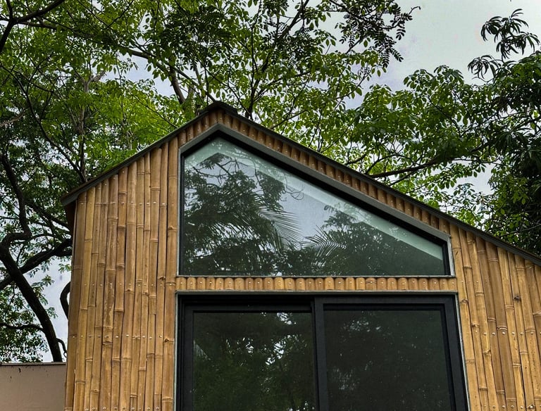 a bamboo house with a large window