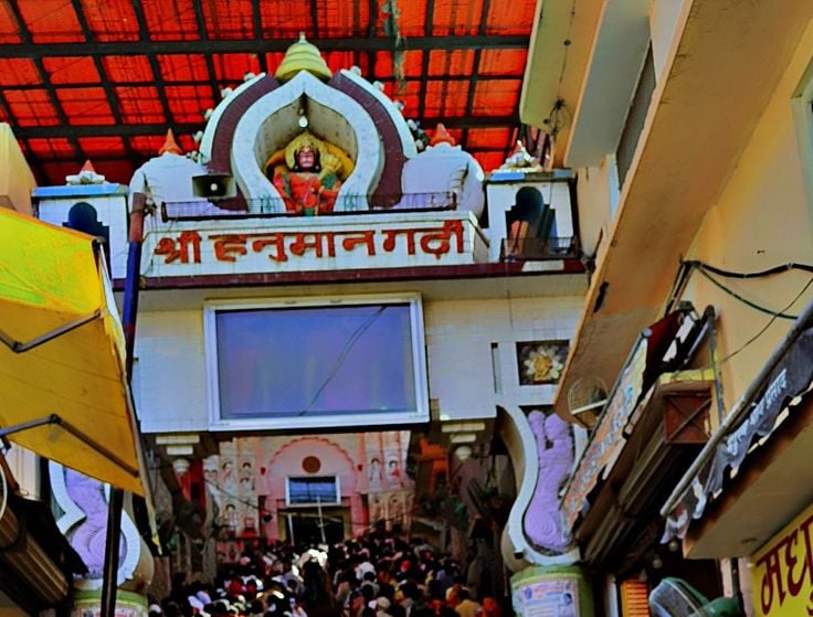 a person holding a bunch of flowers in front of a building