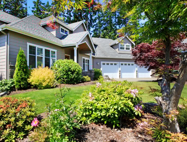 Residential landscape with layered perennials, shrubs, and a well-kept WNY garden.