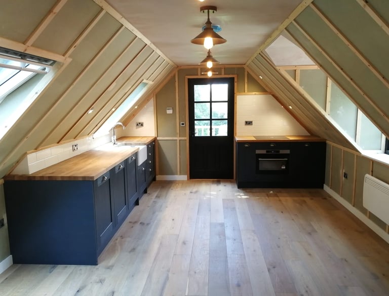 a kitchen with a wooden floor and a wooden floor