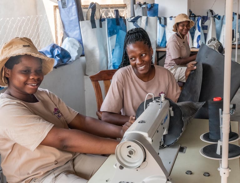Young woman sewing grow bags to plant trees