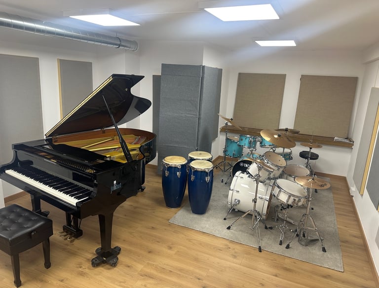 a piano and drums in a room with latin percussion 
