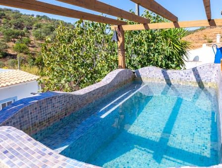 a pool with a wooden deck and a pool
