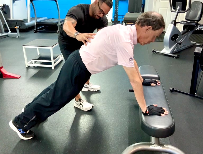 fitness coach helping man with push up form