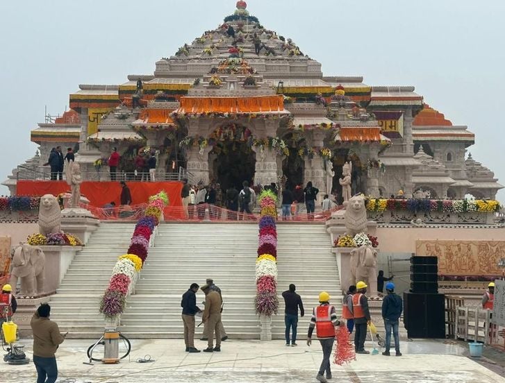 a group of people standing around a large building